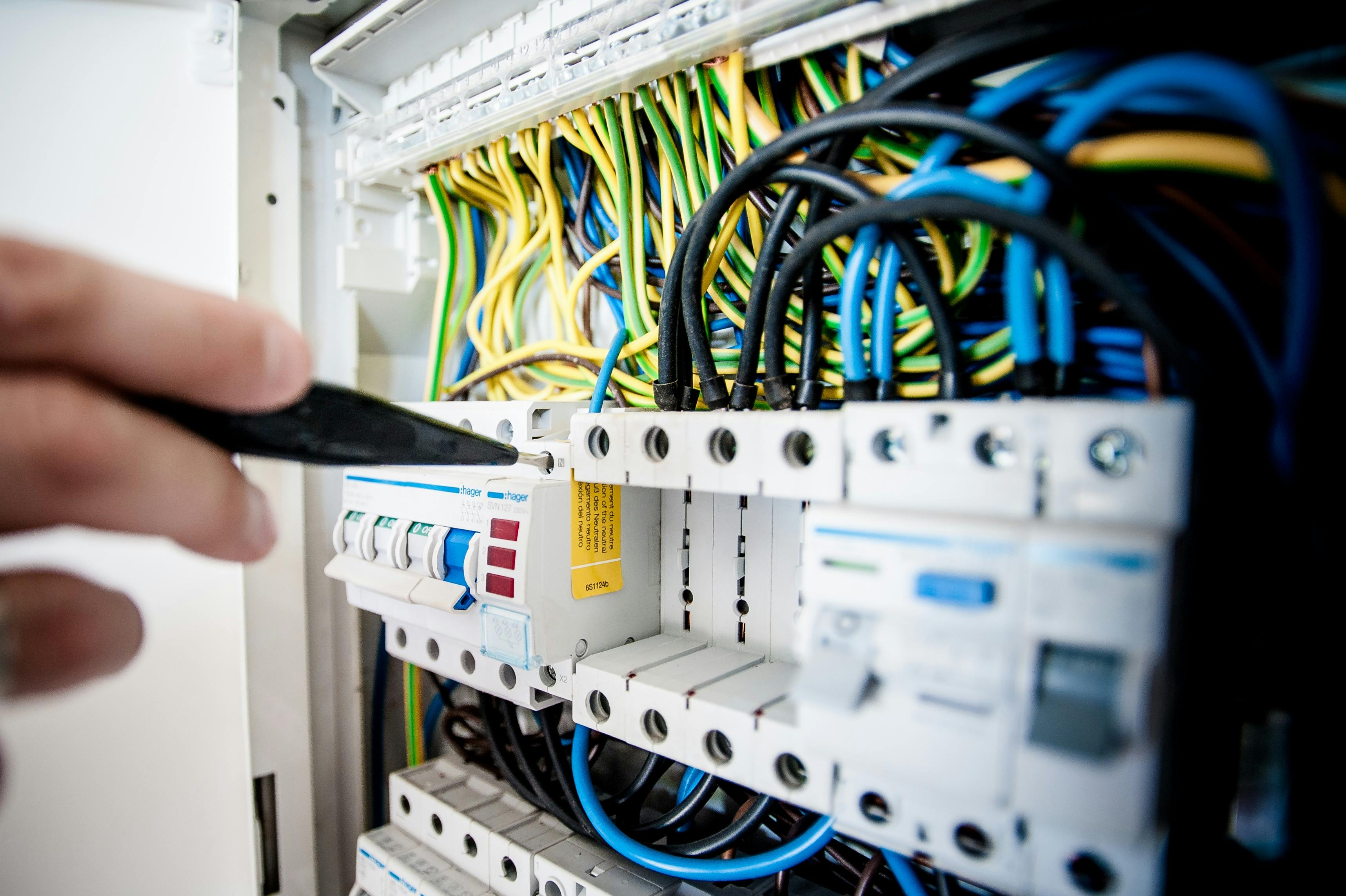 a switchboard being worked on by an electrician